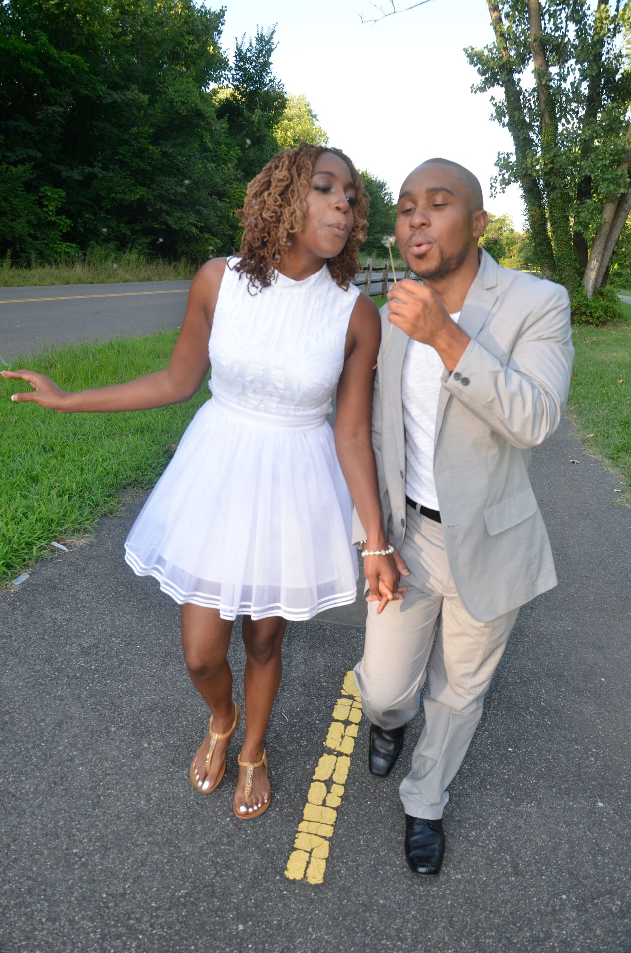 couple blowing dandelion together